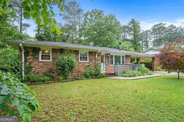 890 Oriole Ln, Marietta, GA 30067 - ranch-style home featuring a front lawn, brick siding, covered porch, and a carport