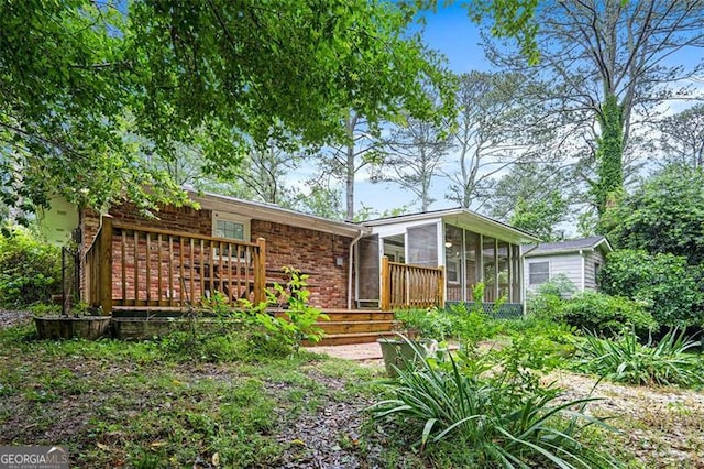 890 Oriole Ln, Marietta, GA 30067 - back of house featuring a sunroom, brick siding, and a wooden deck