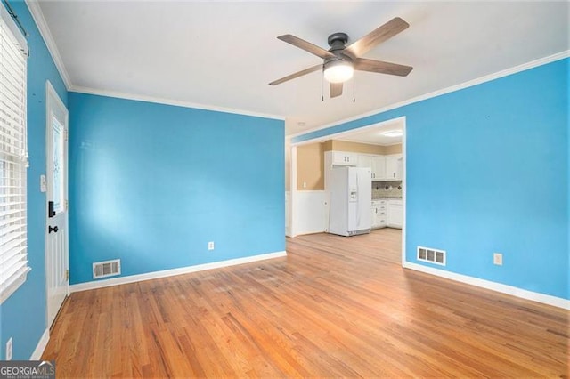 890 Oriole Ln, Marietta, GA 30067 - spare room with ceiling fan, baseboards, ornamental molding, light wood finished floors, and healthy amount of natural light