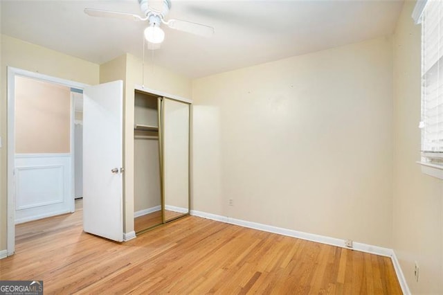 890 Oriole Ln, Marietta, GA 30067 - unfurnished bedroom with light wood-style flooring, a closet, baseboards, and ceiling fan