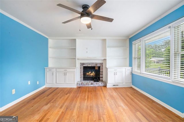 890 Oriole Ln, Marietta, GA 30067 - unfurnished living room featuring baseboards, wood finished floors, a ceiling fan, a stone fireplace, and crown molding