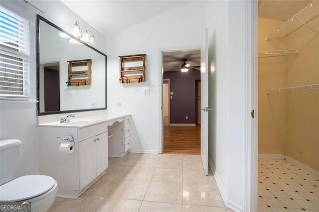 890 Oriole Ln, Marietta, GA 30067 - bathroom with lofted ceiling, toilet, ceiling fan, vanity, and tile patterned flooring