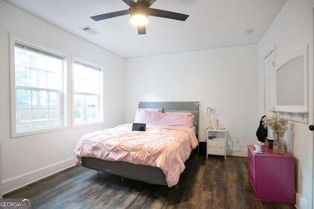 bedroom with wood finished floors, baseboards, and a ceiling fan