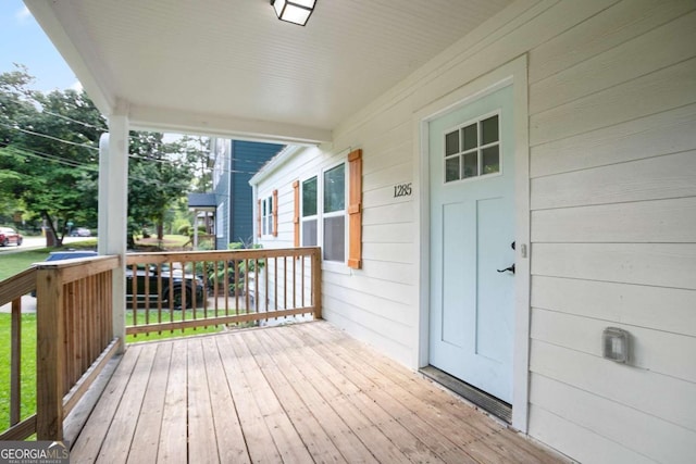 wooden terrace featuring covered porch