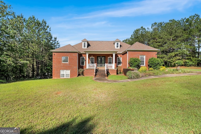 166 Freedom Ln, Commerce, GA 30530 - view of front of house with a porch, brick siding, and a front lawn