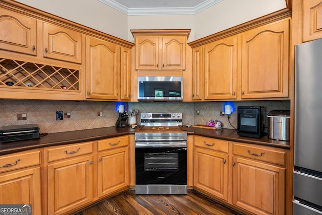 166 Freedom Ln, Commerce, GA 30530 - kitchen with appliances with stainless steel finishes, dark countertops, crown molding, tasteful backsplash, and dark wood finished floors