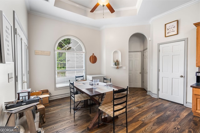 166 Freedom Ln, Commerce, GA 30530 - dining room featuring arched walkways, dark wood finished floors, a raised ceiling, a ceiling fan, and crown molding