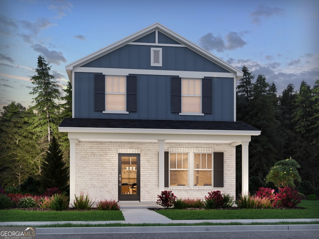 4780 Hemingway Trl, Cumming, GA 30041 - view of front facade featuring board and batten siding, brick siding, and covered porch