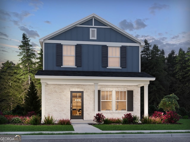 4780 Hemingway Trl, Cumming, GA 30041 - view of front facade featuring board and batten siding, brick siding, and covered porch