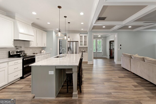 1050 Forrest Highlands, Greensboro, GA 30642 - kitchen with stainless steel appliances, a sink, open floor plan, tasteful backsplash, and a kitchen breakfast bar