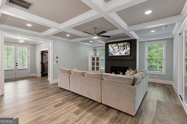 1050 Forrest Highlands, Greensboro, GA 30642 - living room with baseboards, a large fireplace, wood finished floors, beam ceiling, and ceiling fan