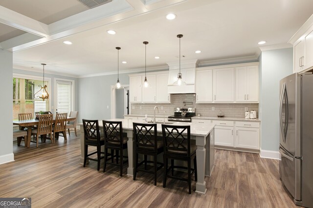 1050 Forrest Highlands, Greensboro, GA 30642 - kitchen with stainless steel appliances, ornamental molding, baseboards, backsplash, and wood finished floors
