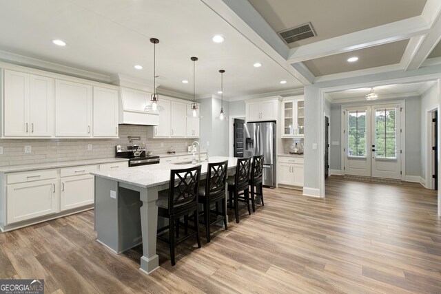 1050 Forrest Highlands, Greensboro, GA 30642 - kitchen with stainless steel appliances, crown molding, a sink, backsplash, and a breakfast bar