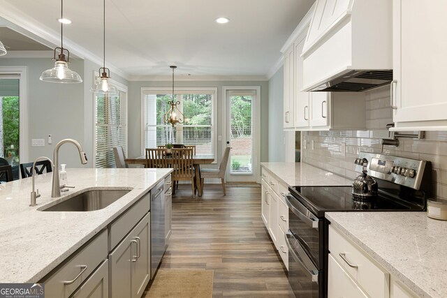 1050 Forrest Highlands, Greensboro, GA 30642 - kitchen with appliances with stainless steel finishes, wall chimney range hood, a sink, crown molding, and dark wood finished floors