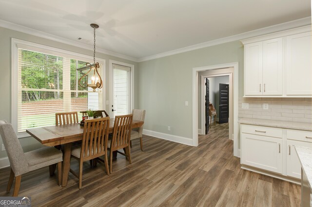 1050 Forrest Highlands, Greensboro, GA 30642 - dining space with crown molding, dark wood-type flooring, baseboards, and a chandelier