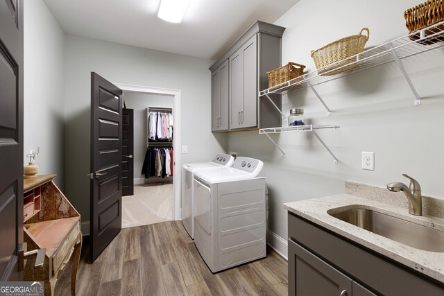 1050 Forrest Highlands, Greensboro, GA 30642 - washroom featuring washer and clothes dryer, dark wood-style floors, and cabinet space