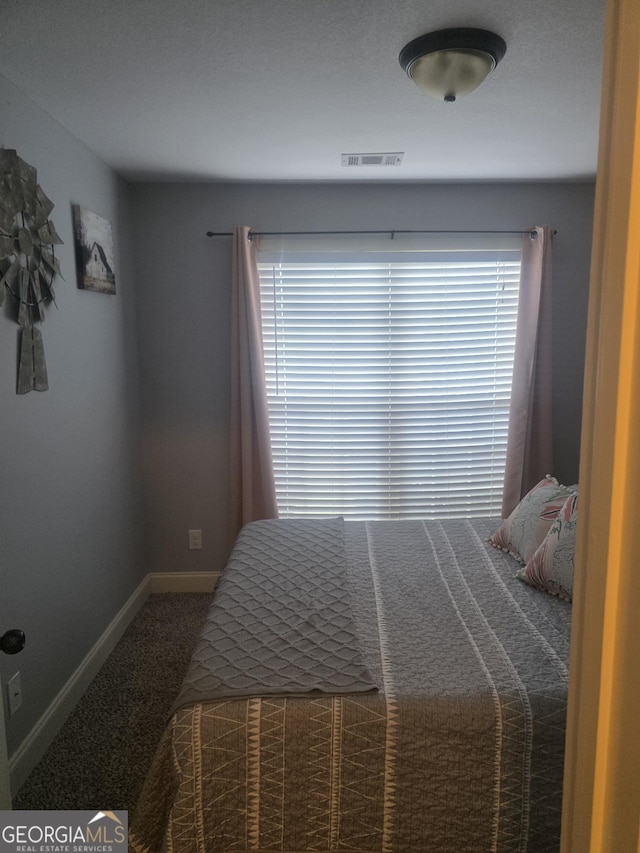 bedroom featuring carpet flooring and baseboards