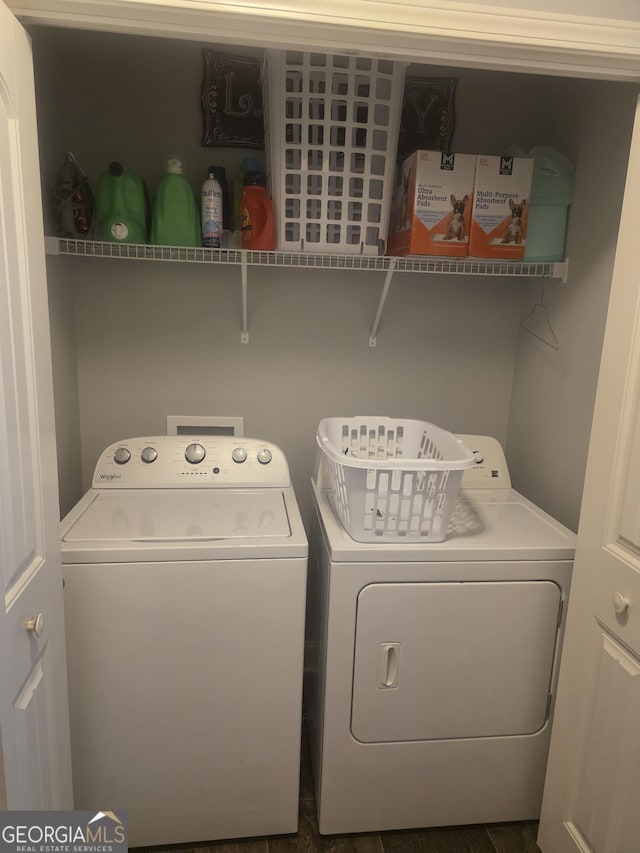 clothes washing area featuring washer and clothes dryer
