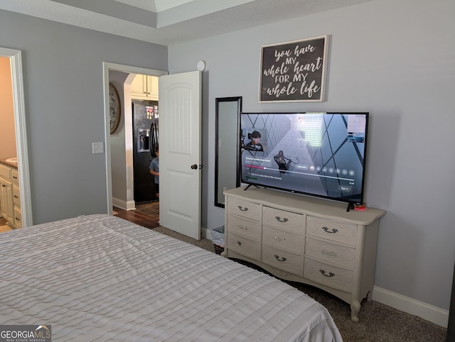 bedroom with baseboards and carpet
