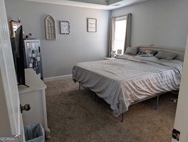 carpeted bedroom featuring baseboards