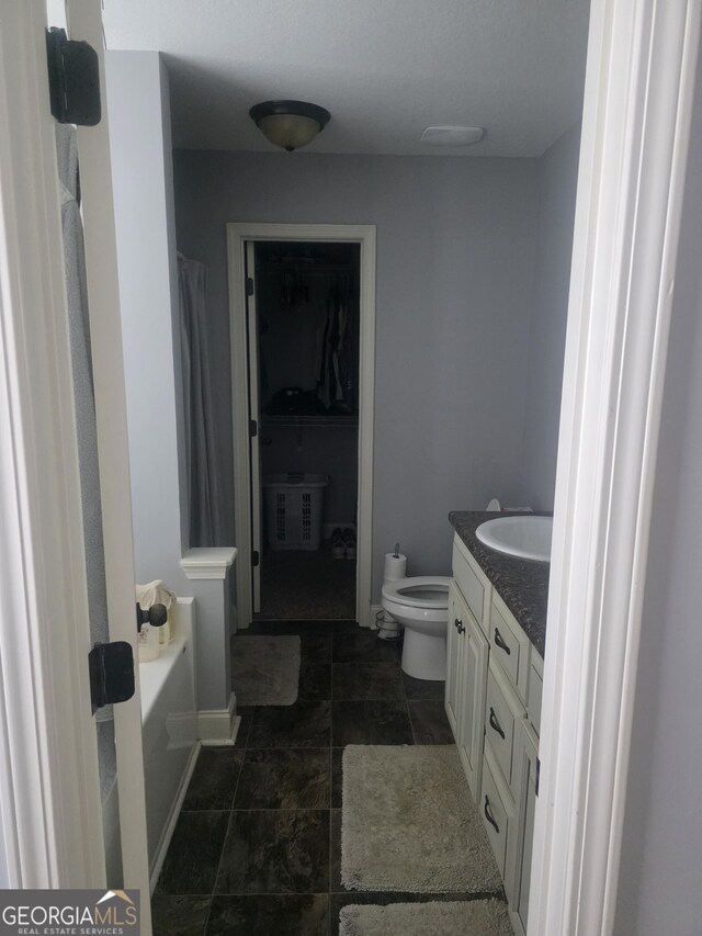 full bath featuring vanity, a shower with shower curtain, toilet, a bathtub, and baseboards