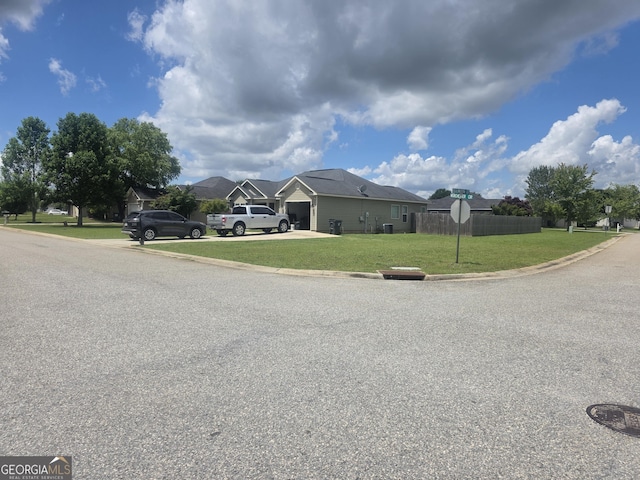 view of front facade with driveway, an attached garage, and a residential view