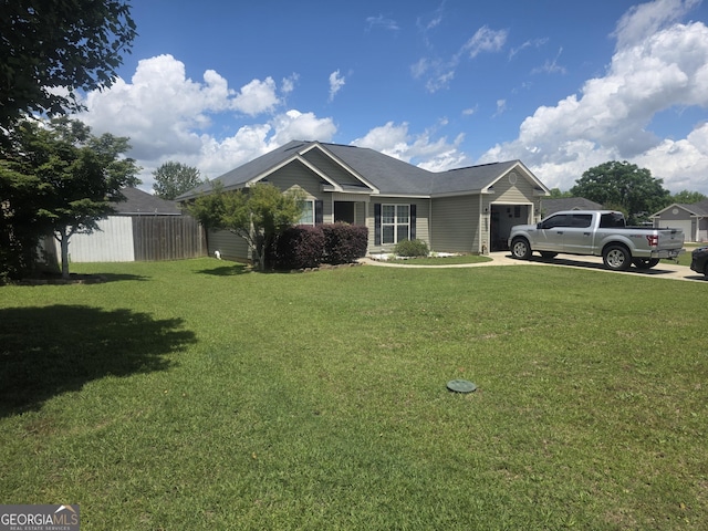 view of front of property featuring an attached garage, a front yard, and driveway