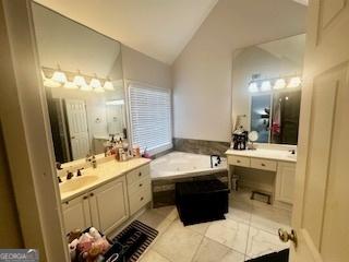 232 Spalding Gates Dr, Atlanta, GA 30328 - bathroom with lofted ceiling, two vanities, and a garden tub