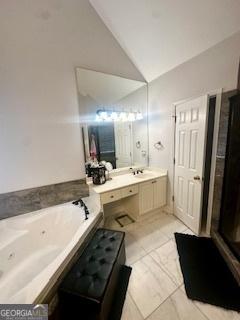 232 Spalding Gates Dr, Atlanta, GA 30328 - bathroom with vaulted ceiling, a whirlpool tub, marble look tile flooring, and vanity