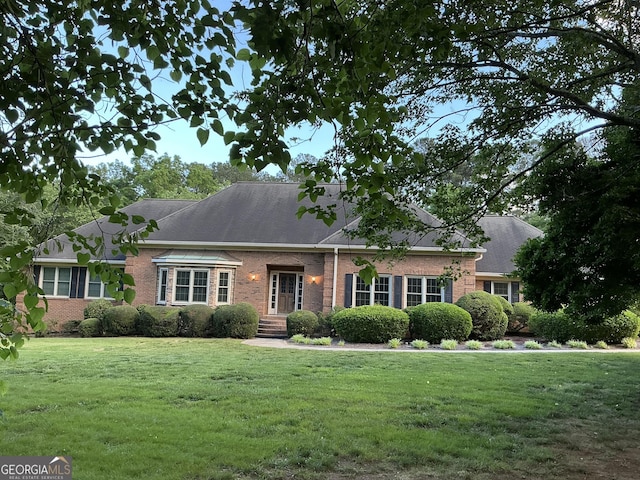 2451 Old Salem Cir SE, Conyers, GA 30013 - view of front of home featuring brick siding and a front lawn