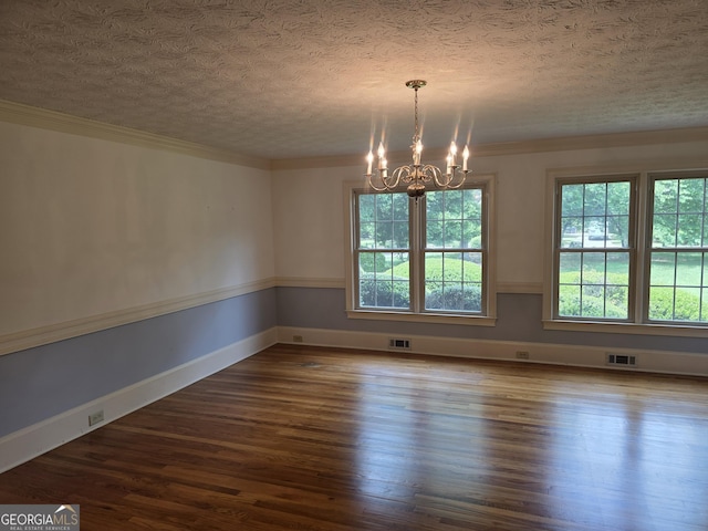2451 Old Salem Cir SE, Conyers, GA 30013 - unfurnished room with plenty of natural light, a textured ceiling, a chandelier, wood finished floors, and crown molding