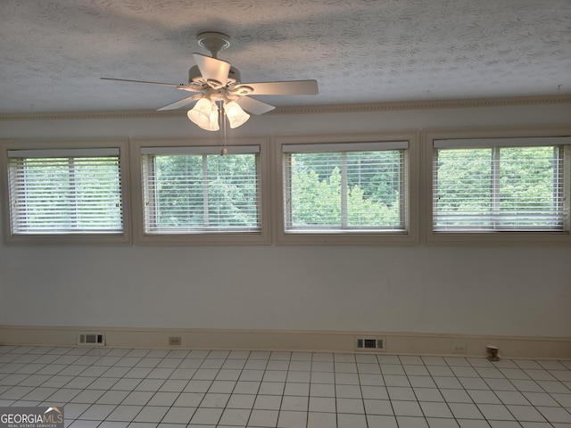 2451 Old Salem Cir SE, Conyers, GA 30013 - unfurnished room with plenty of natural light, a ceiling fan, a textured ceiling, and light tile patterned floors