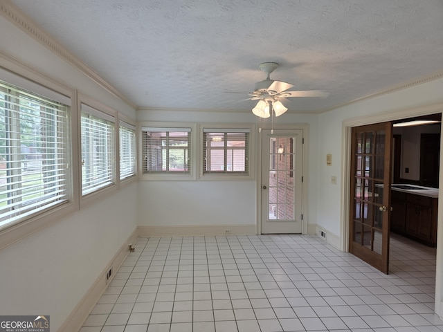 2451 Old Salem Cir SE, Conyers, GA 30013 - unfurnished sunroom with healthy amount of natural light, tile patterned floors, crown molding, baseboards, and a textured ceiling
