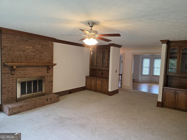 2451 Old Salem Cir SE, Conyers, GA 30013 - unfurnished living room featuring light carpet, ceiling fan, baseboards, ornamental molding, and a fireplace