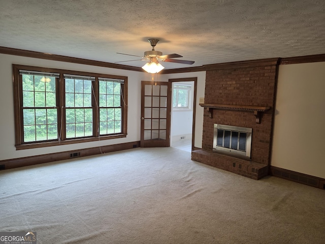 2451 Old Salem Cir SE, Conyers, GA 30013 - unfurnished living room featuring crown molding, carpet floors, a ceiling fan, a fireplace, and a textured ceiling