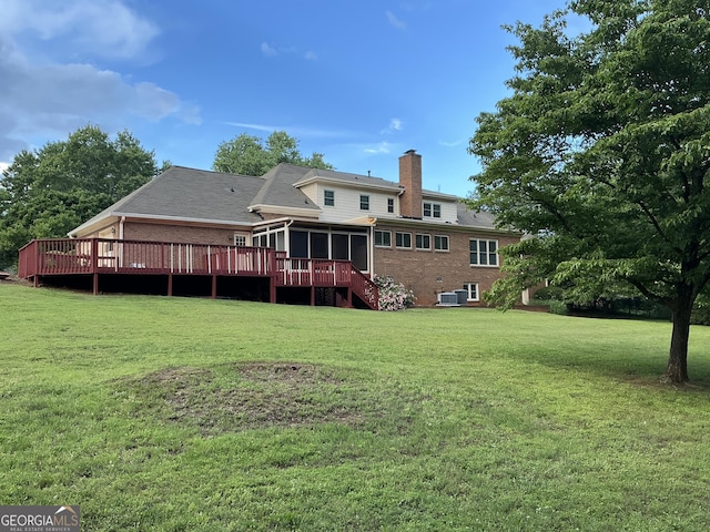 2451 Old Salem Cir SE, Conyers, GA 30013 - back of house with a chimney, a sunroom, brick siding, and a lawn