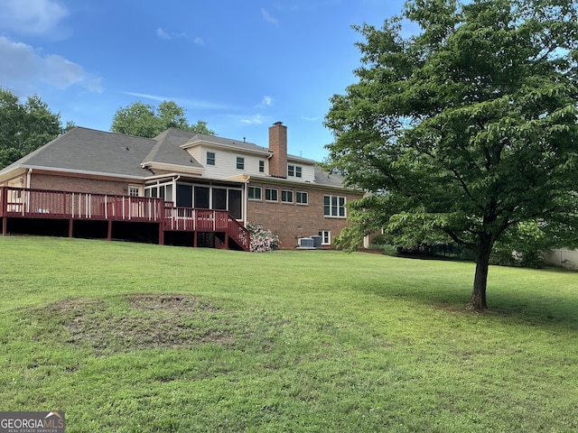 2451 Old Salem Cir SE, Conyers, GA 30013 - back of property with a chimney, a sunroom, brick siding, and a lawn
