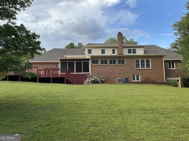 2451 Old Salem Cir SE, Conyers, GA 30013 - rear view of property featuring a sunroom, a chimney, brick siding, and a lawn