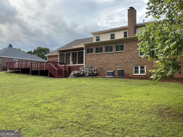 2451 Old Salem Cir SE, Conyers, GA 30013 - back of house featuring a sunroom, brick siding, a chimney, a lawn, and a deck