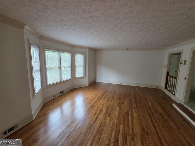 2451 Old Salem Cir SE, Conyers, GA 30013 - unfurnished living room featuring wood finished floors, a textured ceiling, crown molding, and baseboards