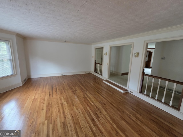 2451 Old Salem Cir SE, Conyers, GA 30013 - spare room with a textured ceiling, wood finished floors, and baseboards