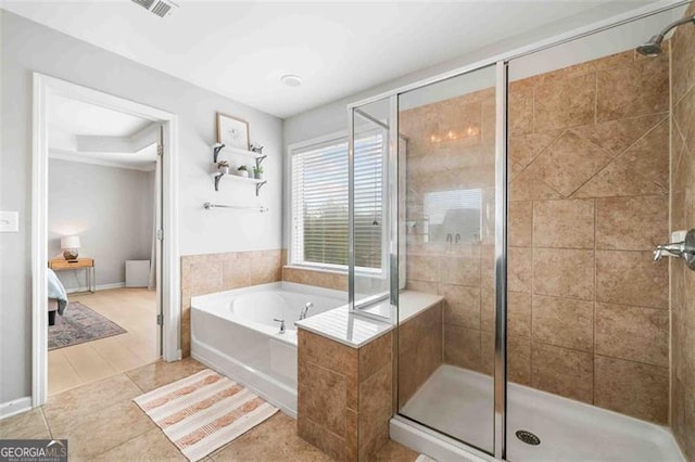 bathroom featuring ensuite bath, a stall shower, tile patterned floors, and a garden tub
