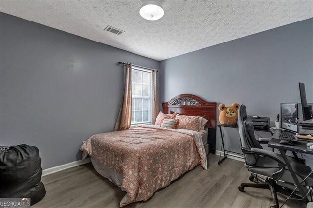 575 Chapel Walk, Lawrenceville, GA 30045 - bedroom with wood finished floors, an office area, and a textured ceiling
