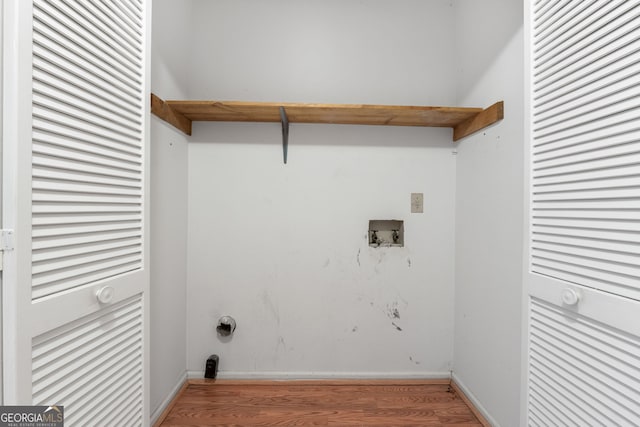 washroom featuring wood finished floors, hookup for a washing machine, and baseboards