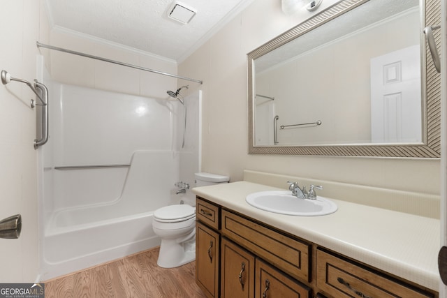 full bathroom with ornamental molding, toilet, wood finished floors, vanity, and shower / tub combination
