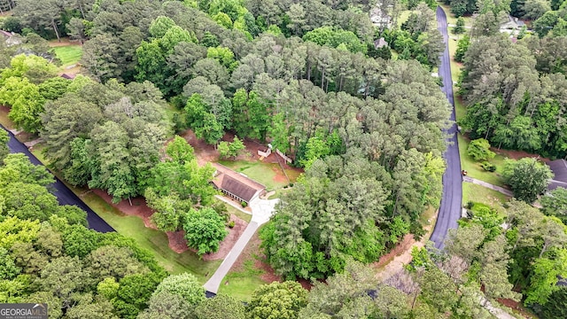 aerial view of property and surrounding area with a forest