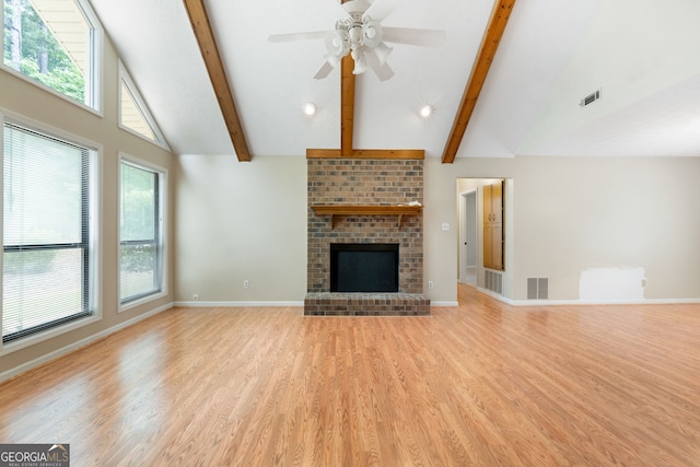 unfurnished living room with light wood-type flooring, beam ceiling, a ceiling fan, baseboards, and high vaulted ceiling