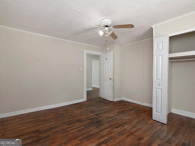 6296 Longino Dr, Union City, GA 30291 - unfurnished bedroom with dark wood finished floors, baseboards, a closet, ceiling fan, and a textured ceiling
