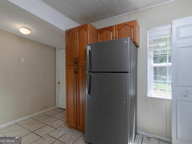 6296 Longino Dr, Union City, GA 30291 - kitchen with freestanding refrigerator, baseboards, and brown cabinetry