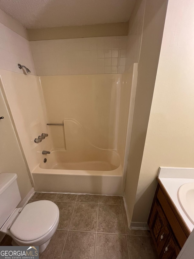 full bathroom featuring toilet, vanity, tile patterned flooring, and shower / bath combination